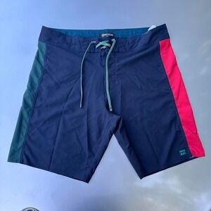 Navy blue Billabong board shorts with red and green side panels and drawstring